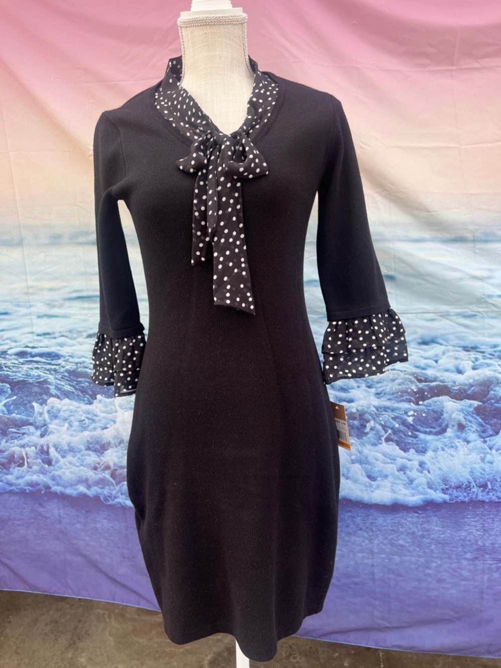 black Hailey Lyn sweater dress featuring a polka-dot tie neck and ruffled cuffs